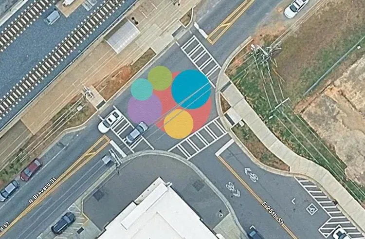 Aerial view of a road mural with coloured circles